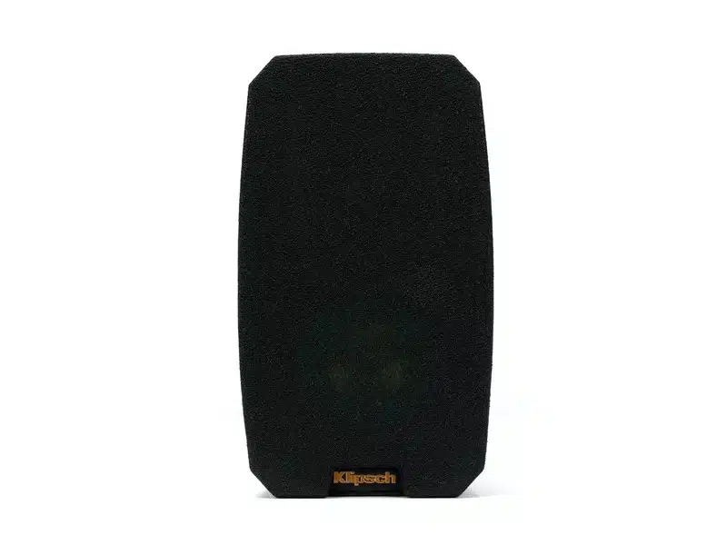 Klipsch Reference Theater Pack 5.0 Klipsch bookshelf speaker with black fabric grille and orange logo at bottom.