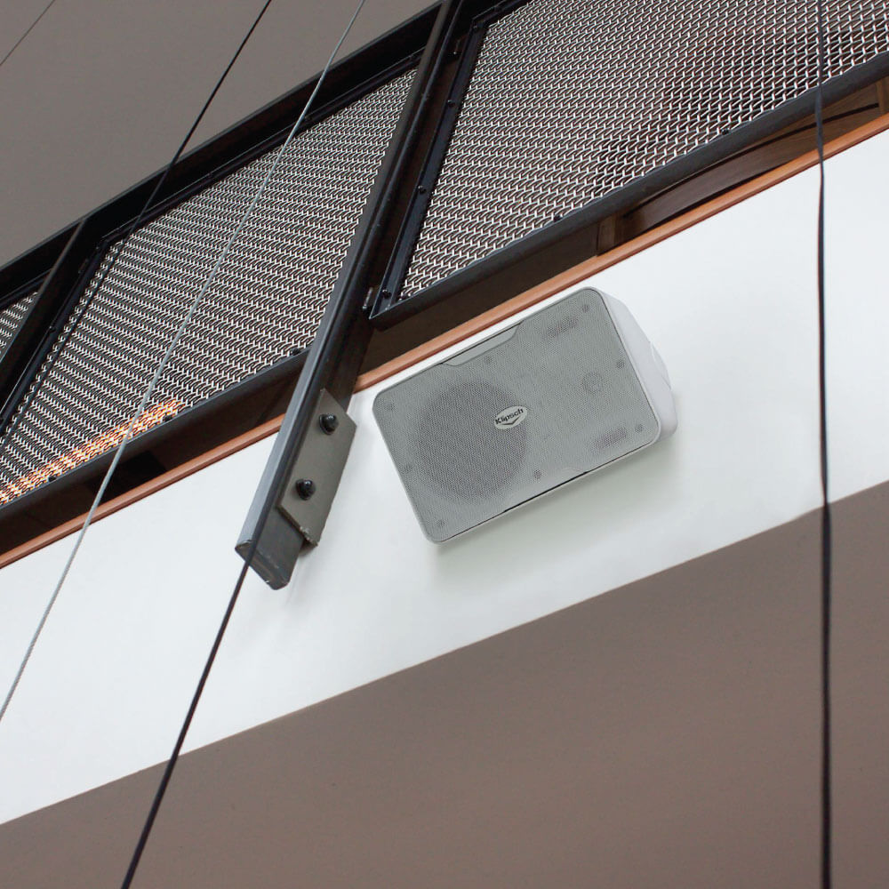 Klipsch Cp-6T - Sold As Pair White wall-mounted speaker with a perforated grille and rounded edges, featuring a centered brand logo.