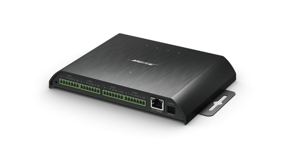 Bose Controlspace Ex-8Ml 8Ch Mic/Gpio Dante Utb Bose-branded industrial control module with multiple green terminal blocks, ethernet port, and wall-mount bracket in brushed metal housing.