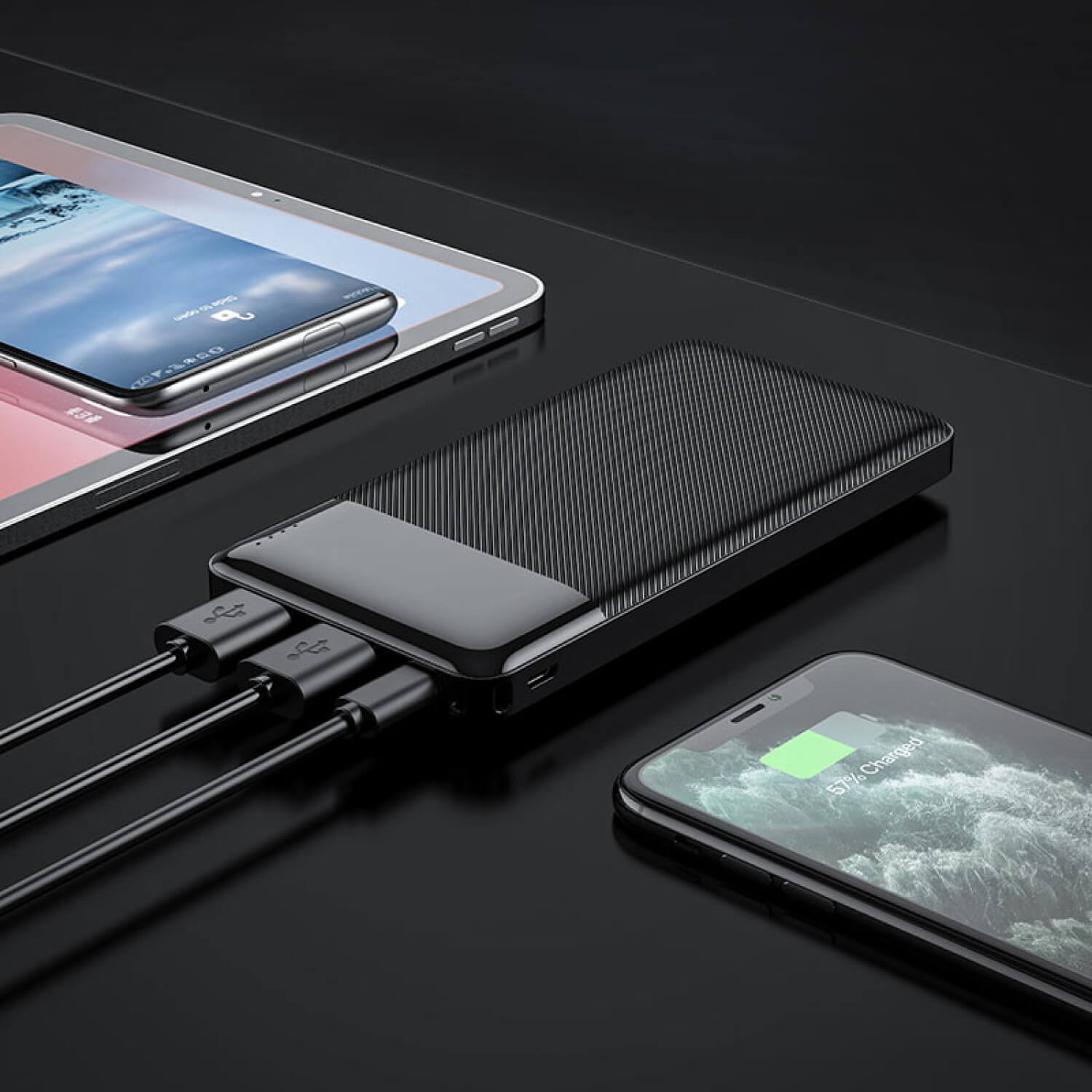 Hoco Power Bank “J72 Easy Travel” 10000Mah Black ribbed external power bank connected to smartphones with usb charging cables.