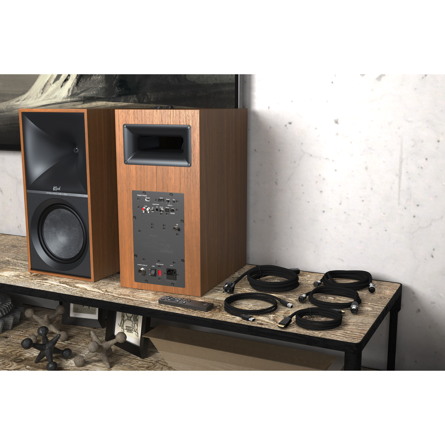 Klipsch The Nines Pair of walnut klipsch loudspeakers with horn-loaded tweeters and large woofers on a wooden desk.