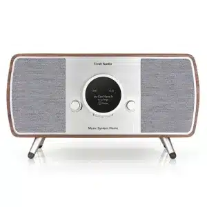 Tivoli Audio Music System Home with wood veneer, circular central display, two fabric speakers, and angled legs.