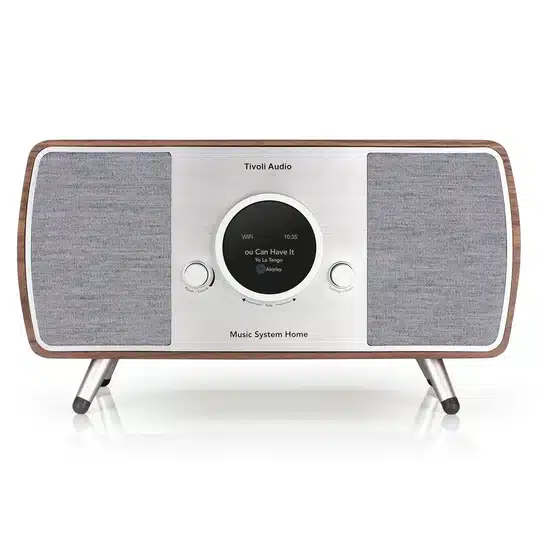 Tivoli Audio Music System Home (Gen. 2) Tivoli audio music system home with wood veneer, circular central display, two fabric speakers, and angled legs.