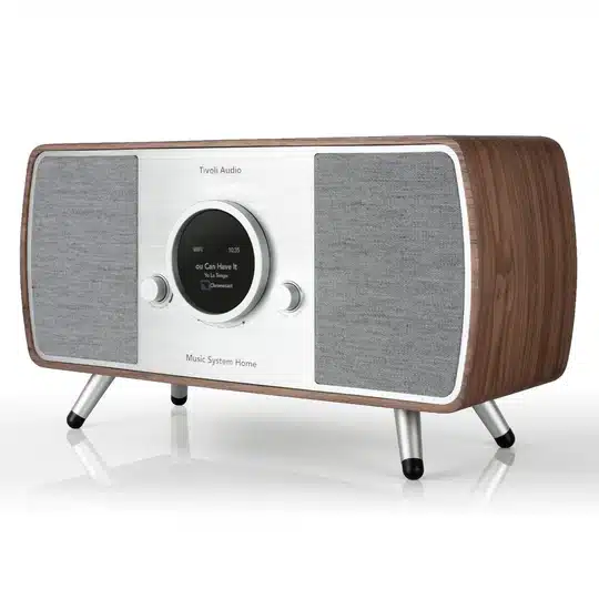 Tivoli Audio Music System Home (Gen. 2) Tivoli audio music system home speaker with wooden cabinet, silver front, round display, gray speaker grilles, metal legs.