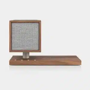 Wooden mid-century speaker with square gray fabric grille on a metal pedestal attached to a wooden base.