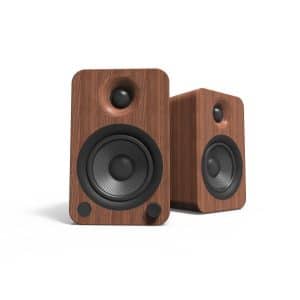 Pair of wooden bookshelf speakers with black drivers and rounded corners.