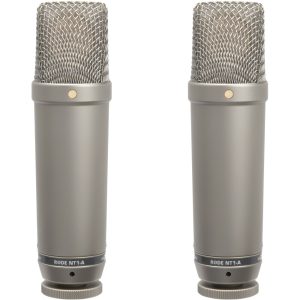 Two Rode NT1-A condenser microphones standing upright with gray bodies and metal mesh grilles.