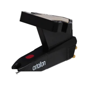 Ortofon black phono cartridge with stylus, gold pins on back, brand name visible.