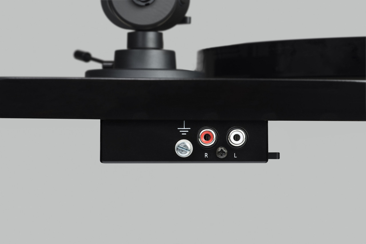 Pro-Ject E1 Phono Turntable With Ortofon Om 5E Cartridge Black turntable base with red and white rca output jacks labeled r and l and grounding connector.