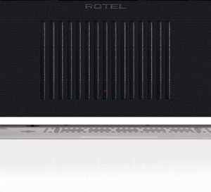Interdyn Rotel power amplifier, black front panel with blue circular power button on left, vertical ventilation grill center, feet.