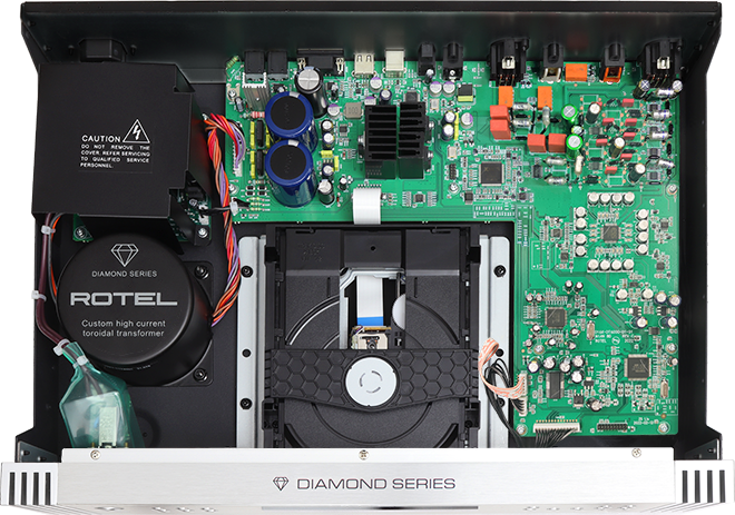 Rotel Dt-6000 Dac Transport Rotel diamond series audio amplifier internals featuring a toroidal transformer and green printed circuit board.
