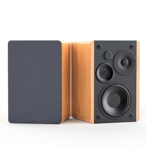Pair of wooden bookshelf speakers, one with a dark fabric grille on and the other exposing a three-driver front panel.