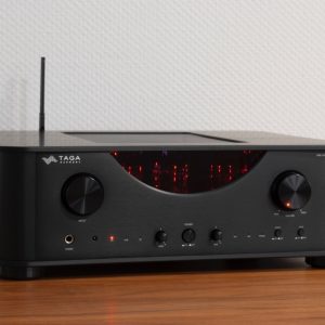Taga Harmony HTA-2000B stereo amplifier with black brushed front, red LED display, large input and volume knobs, headphone jack.