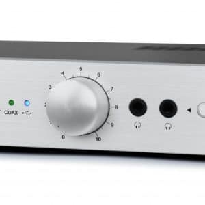 Aural Electronique HD120 headphone amplifier with large silver volume knob, LED indicators, two headphone jacks, and front controls.