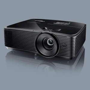 A black projector with a large front lens, ribbed vented sides, and a top control panel.