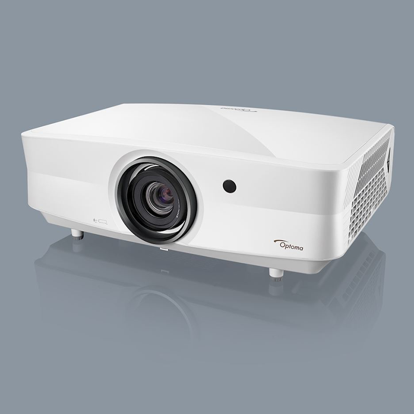 Optoma Zk507 Optoma projector with large front lens, white rectangular body, side ventilation grille, supported by small feet.