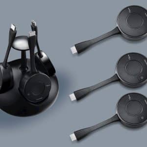 Black wireless over-ear headphones with circular earcups and USB-C connectors; includes charging stand and three spare ear cups.