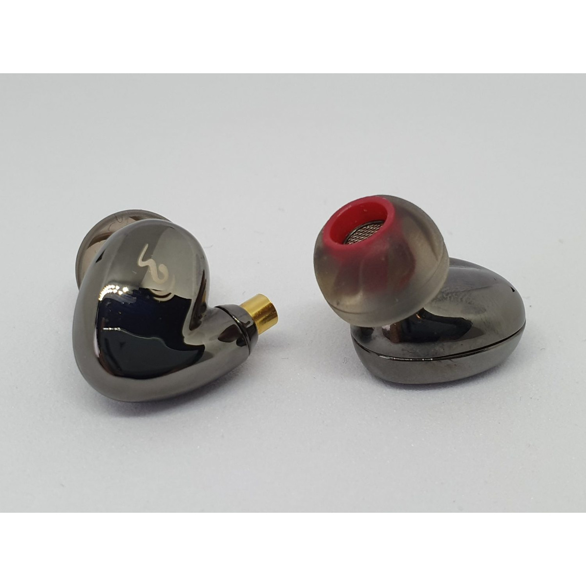Obravo Cupid Basic Pair of smoky gray in-ear monitors with red silicone tips and gold-plated connectors.