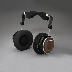 Over-ear planar magnetic headphones with wood veneer ear cups, carbon fiber frame, and padded black headband.