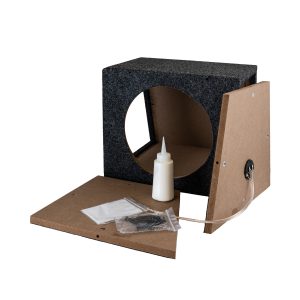 Carpeted speaker cabinet enclosure with circular woofer cutout, glue bottle, screws, and wiring harness for assembly.