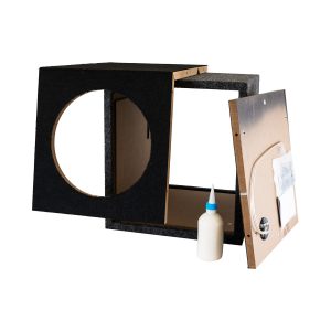 Black carpeted speaker cabinet with circular front cutout, plywood interior, and a removed back panel leaning beside it.