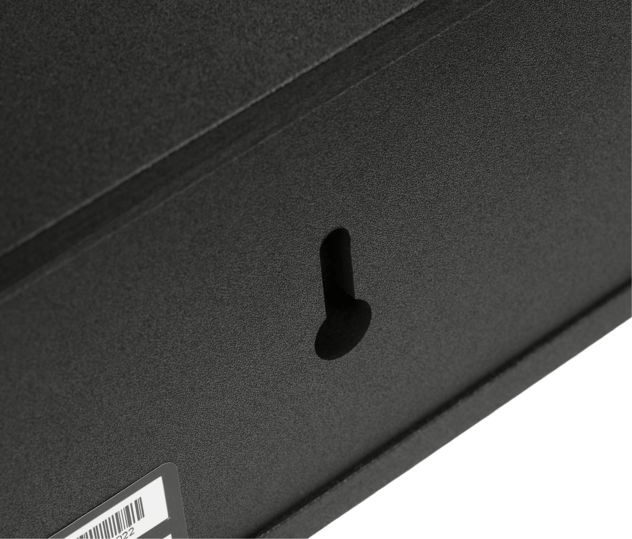 Polk Monitor Xt35 Close-up of a black textured surface with a small curved plastic hook.