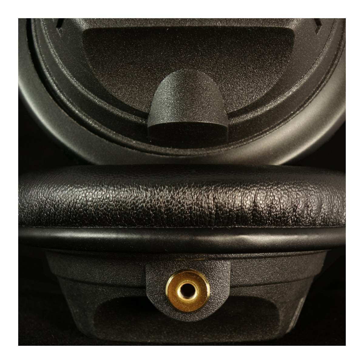 German Maestro Gmp8.35M Advanced Close-up of a black over-ear headphone with leather headband and brass insert at the base.