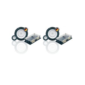 Pair of circular speakers with rectangular amplifier modules and an M logo, featuring gold terminal connectors.