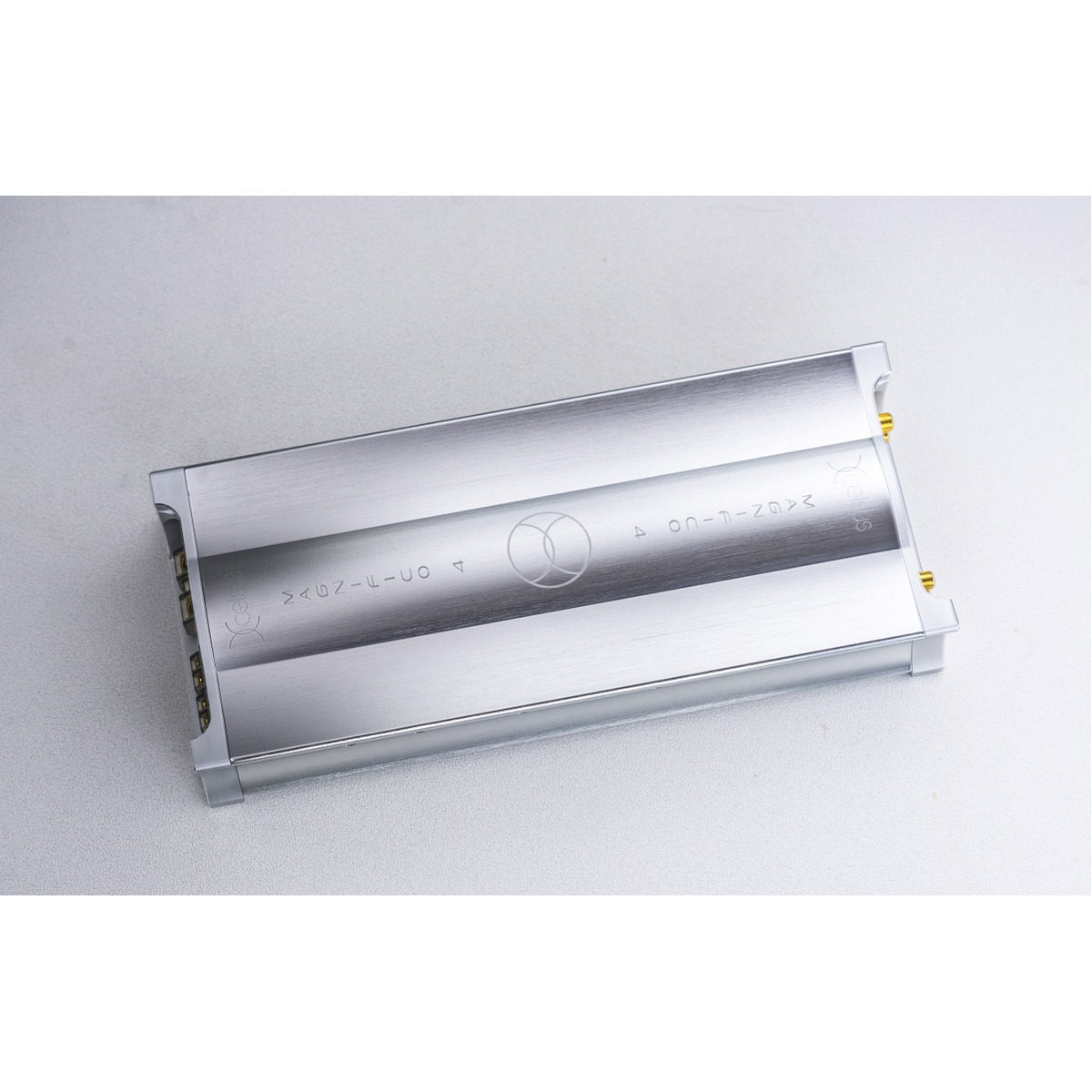 Xcelsus Audio Magn-4 Brushed aluminum power amplifier module with gold binding posts and screw terminals.