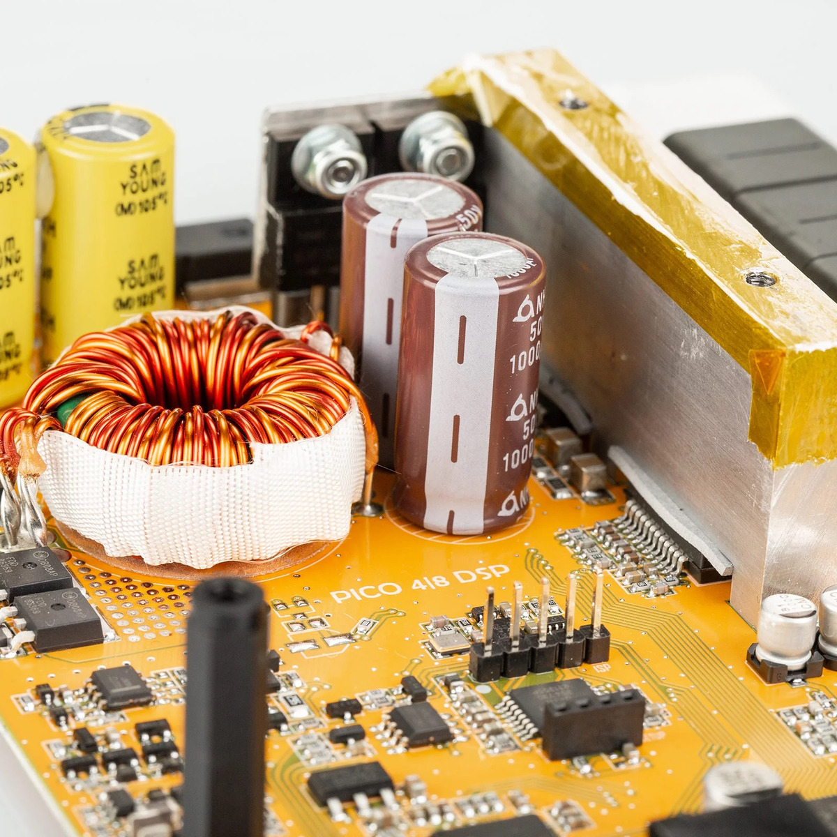 Mosconi Pico-4-8-Dsp Pico 4/8 dsp circuit board featuring a red toroidal inductor, brown electrolytic capacitors, and yellow film caps.