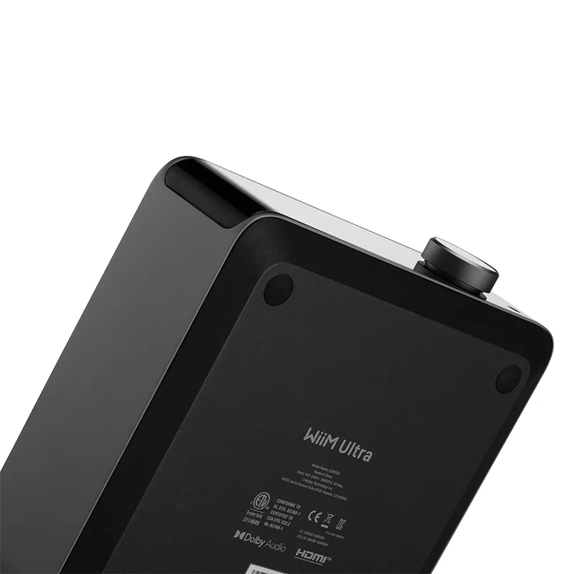 Wiim Ultra Wireless Audio Streamer And Digital Hub Wiim ultra streaming media player with a black matte chassis and round control knob on the top edge.