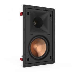 Rectangular black in-wall speaker with copper woofer, small circular tweeter, and red mounting clamps on the sides.