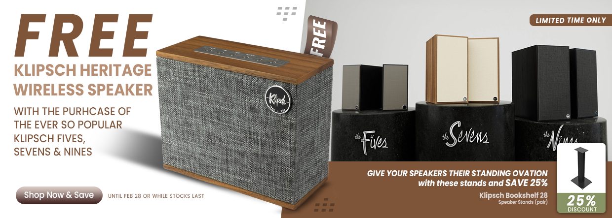 Klipsch heritage wireless speaker with wooden top and gray fabric grille, plus the fives, sevens, and nines on stands.