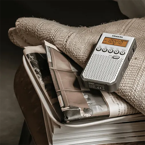 Sangean Dt-800 Am/Fm-Rds Hand-Held Receiver Sangean portable radio with digital display and speaker grille resting on a stack of magazines