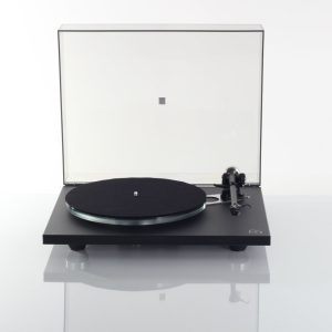 Black turntable with a lifted transparent lid, tonearm on the right, and a black platter mat.