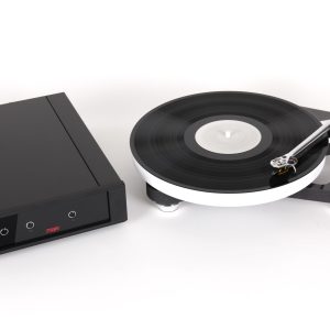 High-end turntable with vinyl record on platter, sleek metal tonearm, and a separate black rectangular component.