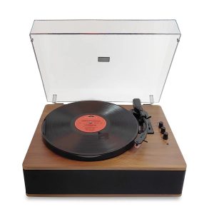 Wooden-base turntable with clear hinged dust cover, black vinyl on platter, tonearm and small control knobs.