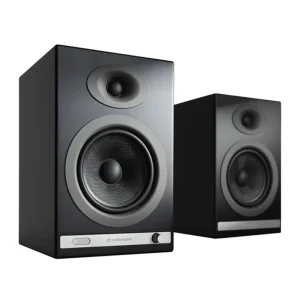 Audioengine bookshelf studio monitor speakers, black finish with large silver-rimmed woofer, small top tweeter and front control strip.