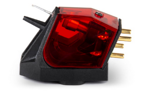 Red transparent phono cartridge with stylus and four gold pins on a black base.