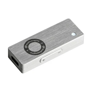 Audioengine USB DAC and headphone amplifier in brushed aluminum, featuring circular control dial, side volume/mute switch, and LED indicator.