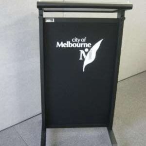 Black lectern with City of Melbourne logo on the front panel.