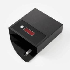 Black plug‑in timer with a red rectangular display and a white circular control on its face.