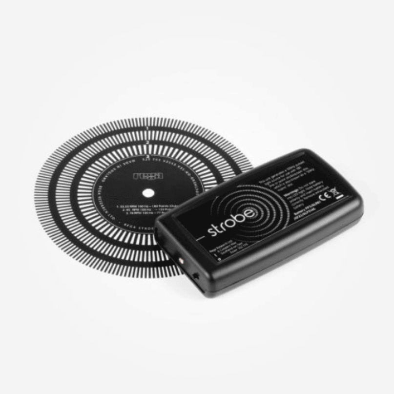 Rega Strobe Kit Strobe battery pack beside a circular, segmented ring accessory.