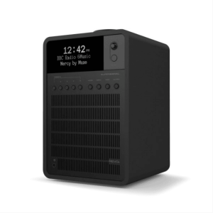 Compact black desktop radio with digital clock display, multiple knobs, front speaker grille, and a top-front camera.