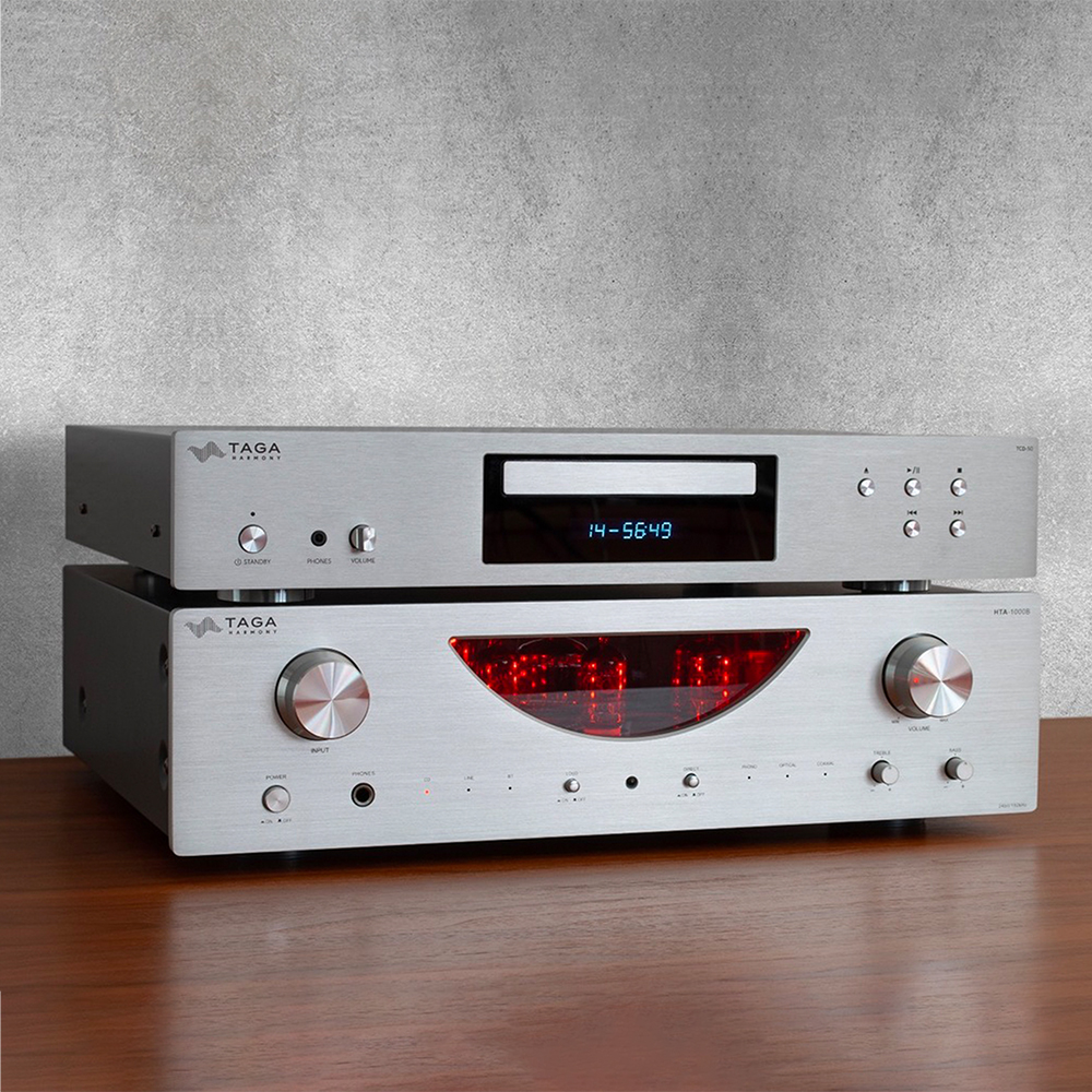 Taga Harmony Hta 1000B Taga harmony stereo amplifier and cd player stack with brushed aluminum finish, blue display, and large knobs.