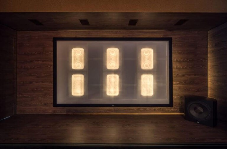 Tdg Audio Iwlcr-66V2 Dual 6.5” 3-Way In-Wall Lcr Speaker Home theater in a wood-paneled room with a screen displaying six illuminated rectangular panels and a speaker in the corner.