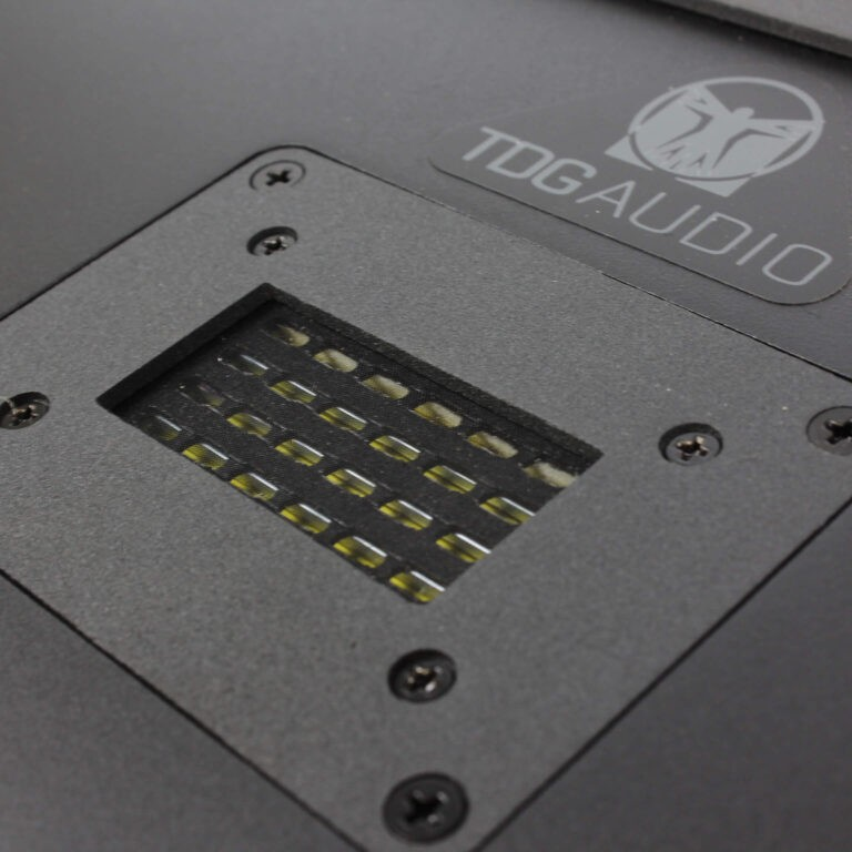 Tdg Audio Iwlcr-66V2 Dual 6.5” 3-Way In-Wall Lcr Speaker Tdg audio device showing a recessed panel with a grid of yellow components.