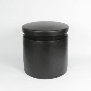 Black cylindrical storage tin with flat lid and subtle seam around the top