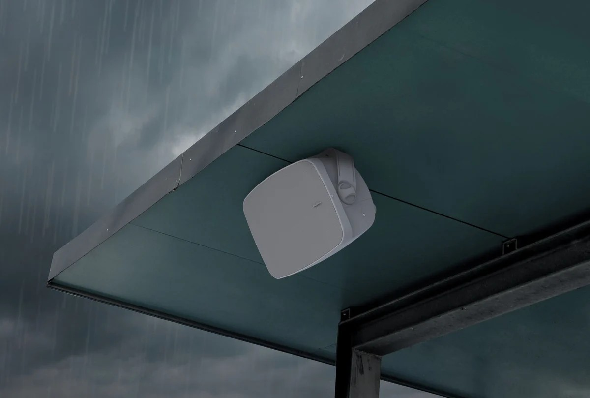 Klipsch Rsm-525 Outdoor white square wireless access point mounted under a teal canopy on a weatherproof bracket.