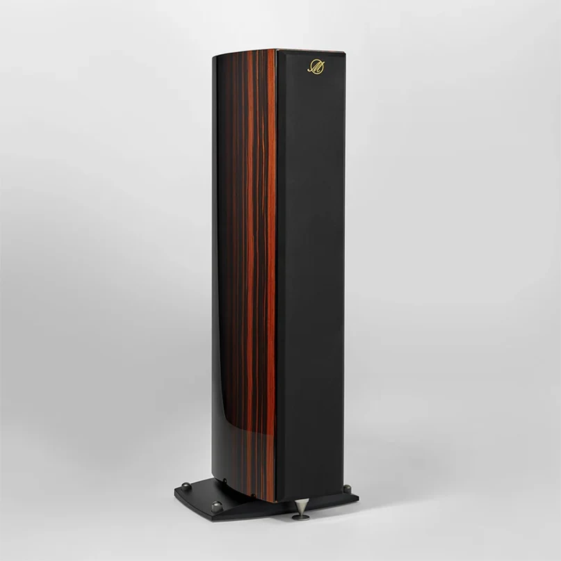 Triangle Magellan Cello 40Th Hi-Fi Floorstanding Speaker Tall floor-standing loudspeaker with wood veneer stripe and black enclosure, gold logo, mounted on a metal base.